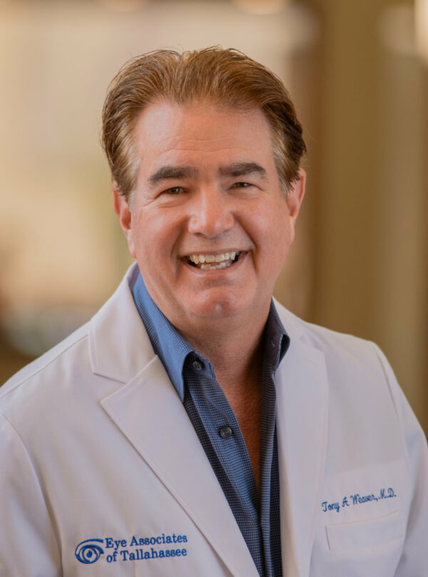 Dr. Weaver headshot in white lab coat, smiling